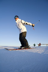 Side view of a young man skiing