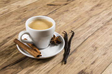 coffe with cinnamon and vanilia on wooden table