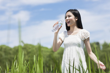 Young woman drinking water outdoors