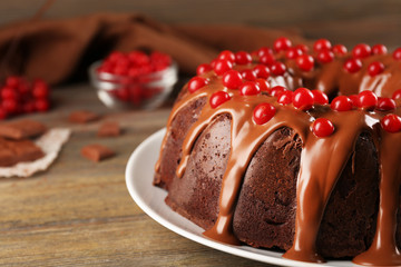 Chocolate cake with snowball tree berries on a table
