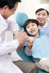 Dentist making promise with a little patient