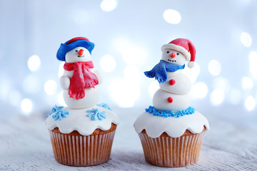 Christmas cupcakes with lights on background