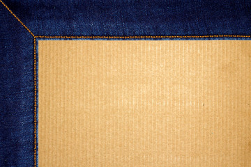 Fototapeta premium Frame of stitched blue jeans on cardboard