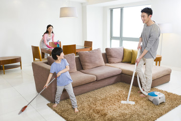 Happy family doing chores at home
