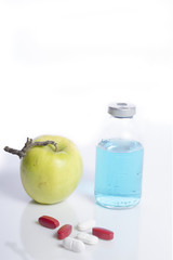 Apple with pharmaceutical product as concept of healthy living 