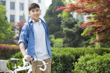 Male college student with bicycle