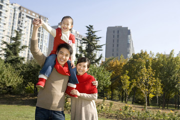 Young Family Enjoying a Park in Autumn