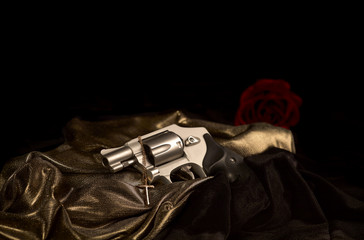 Revolver with a Cross Necklace