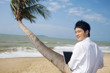 Businessman working at the beach