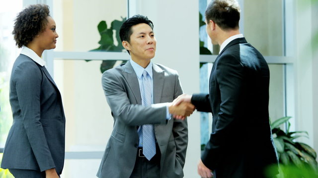 handshake African American Asian Chinese Caucasian male female finance meeting
