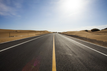 Road going through the desert in Inner Mongolia province, China