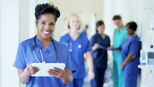 Portrait of African American female staff working on technology in hospital