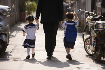 A father picks his children up from school