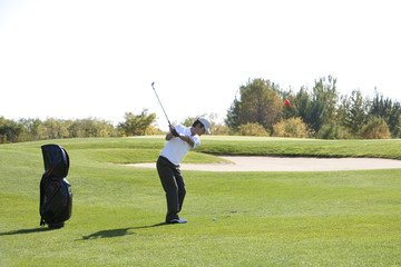 Young Man Taking a Golf Swing