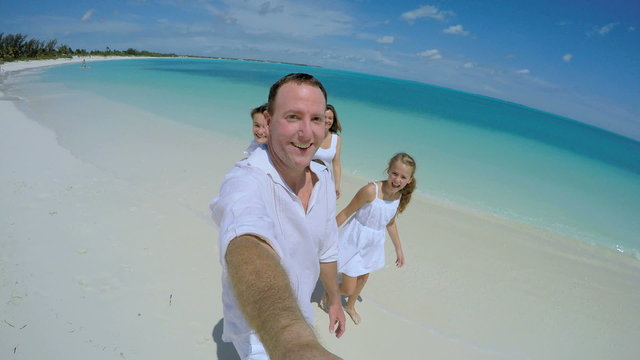 Selfie portrait of Caucasian family enjoying tropical vacation beach 