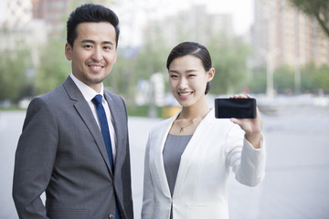 Business person showing smart phone