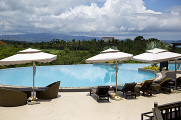 Swimming pool, lounge chairs and umbrellas