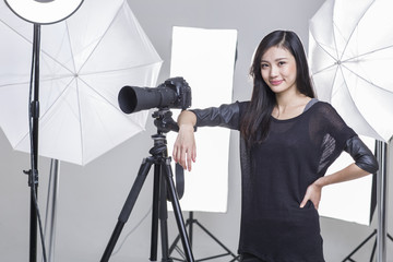 Photographer standing in studio with camera