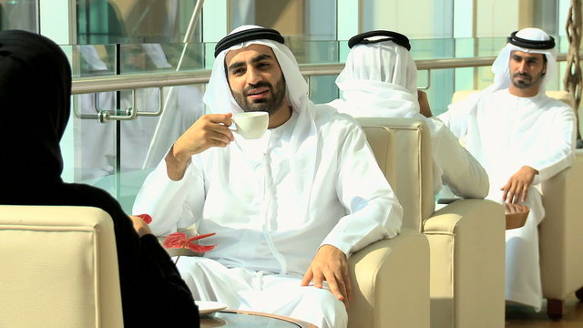 Emirati male business colleagues meeting coffee downtown oil financial 