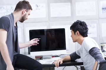 Young adults discussing in office