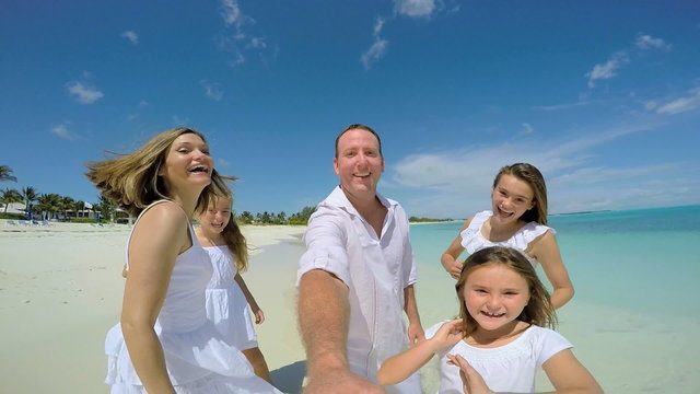 Selfie portrait of Caucasian family enjoying tropical vacation beach 