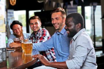 Young men drinking beer in pub