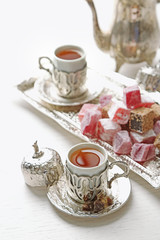 Obraz na płótnie Canvas Antique tea-set with Turkish delight on table close-up