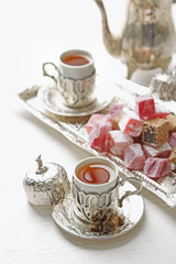 Antique tea-set with Turkish delight on table close-up