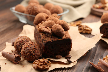 A piece of chocolate cake with walnut on the table, close-up