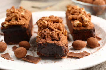 Pieces of chocolate cake with walnut on the table, close-up