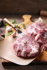 Marbled beef steak and spices on wooden background