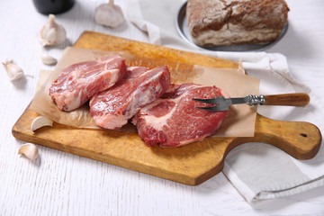 Marbled beef steak and spices on wooden background