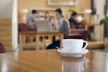 A coffee cup on a table 