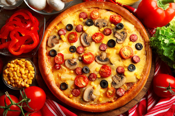 Delicious pizza with vegetables and meat, close-up