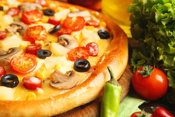 Delicious pizza with vegetables and meat, close-up