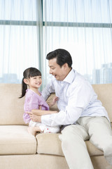 Girl and father on couch