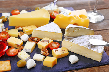 Cheese for tasting on wooden table, closeup