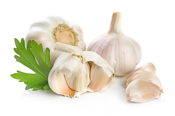 Garlic with leaves of parsley isolated on white