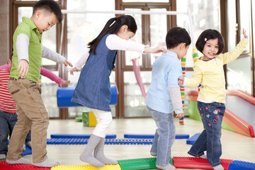 Happy kindergarten children playing games