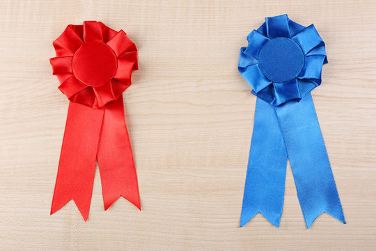 Award ribbons on wooden background