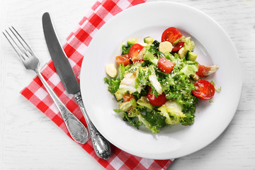 Tasty salmon salad on light wooden background