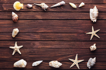 Seashell frame on wooden background