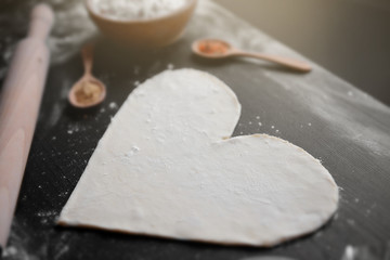 Uncooked heart shaped biscuit on a table