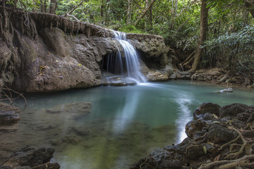 tropical waterfall in deep forest of Kanchanaburi province, Thailand.