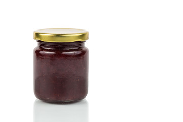 Organic strawberry jam in transparent glass jar