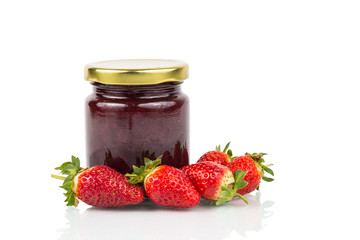 Organic strawberry jam in transparent glass jar with fresh strawberries