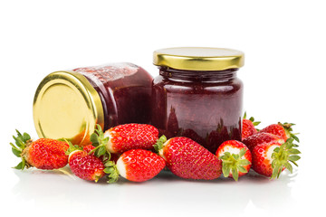 Organic strawberry jam in transparent glass jar with fresh strawberries
