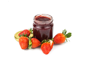 Organic strawberry jam in transparent glass jar with fresh strawberries