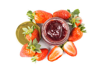 Organic strawberry jam in transparent glass jar with fresh strawberries