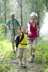 Fototapeta premium Little boy with his grandparents hiking